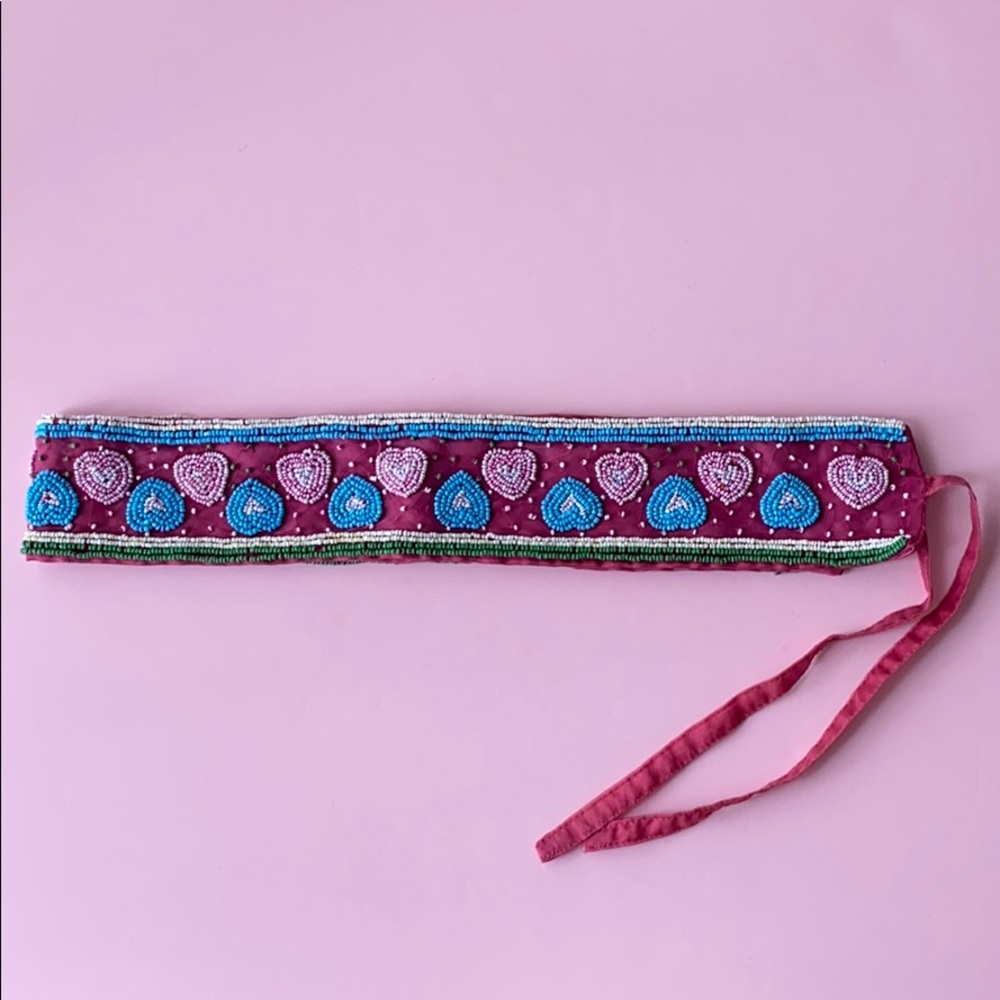 Pink belt with details.